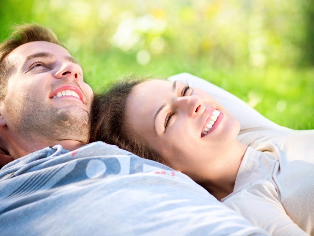 Smiling couple lying in the grass